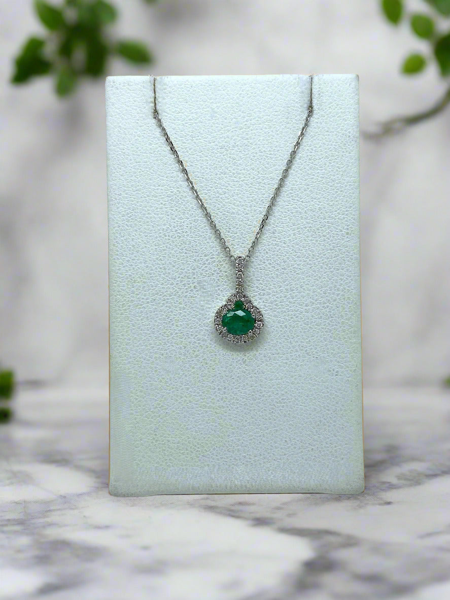 white gold necklace with emerald center stone and diamond halo