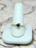 yellow gold ring with trillion-cut sapphire
