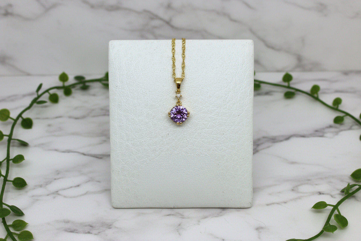 yellow gold necklace with round amethyst pendant with diamond accent