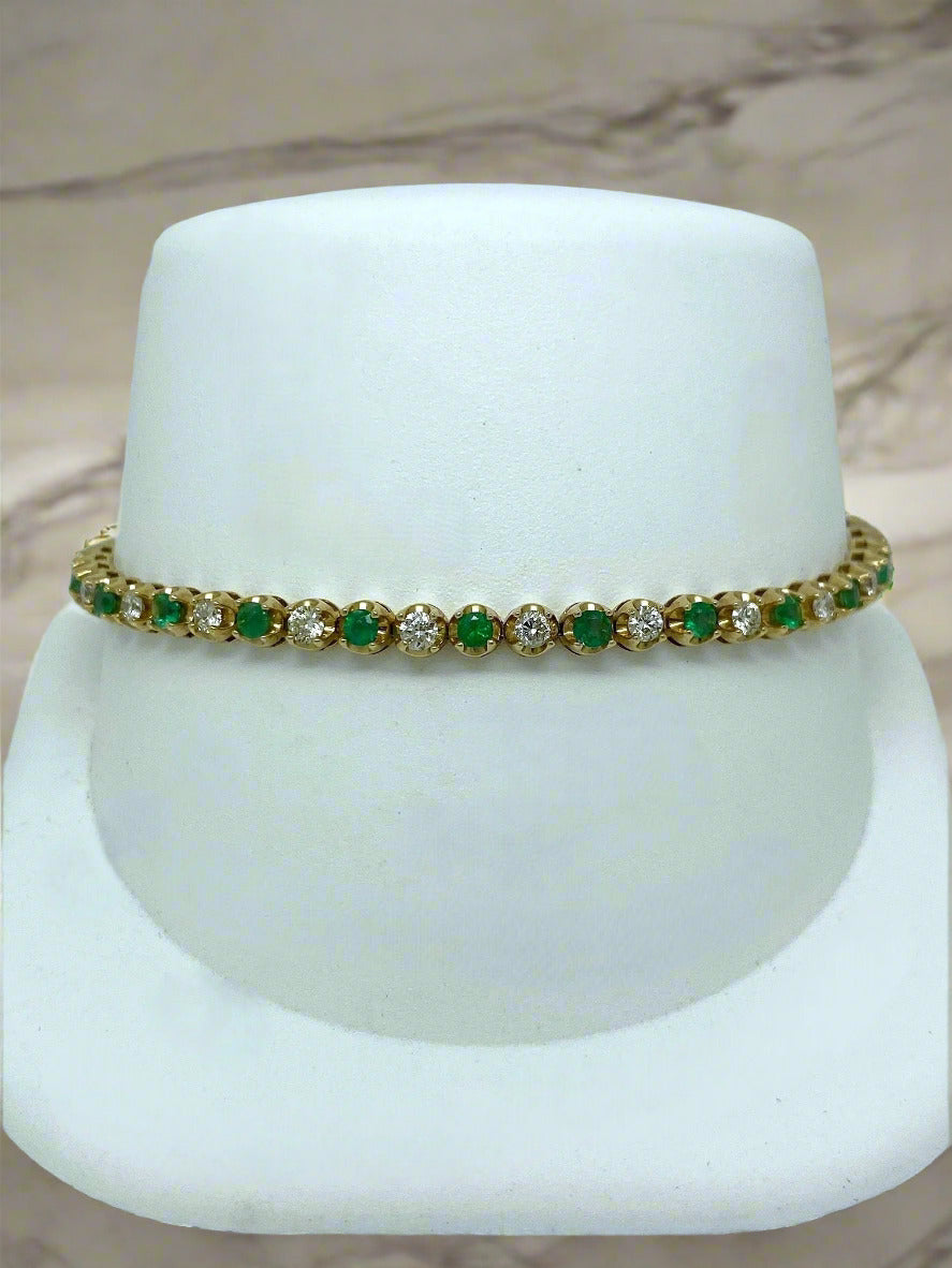 Bracelet with green and clear stones on a white stand