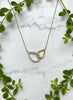 yellow gold interlocking pear-shaped pendants, one pendant is diamond accented