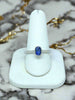 white gold ring with oval bezel-set blue sapphire