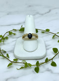 yellow gold ring with split shank accented with diamonds and blue sapphire center stone