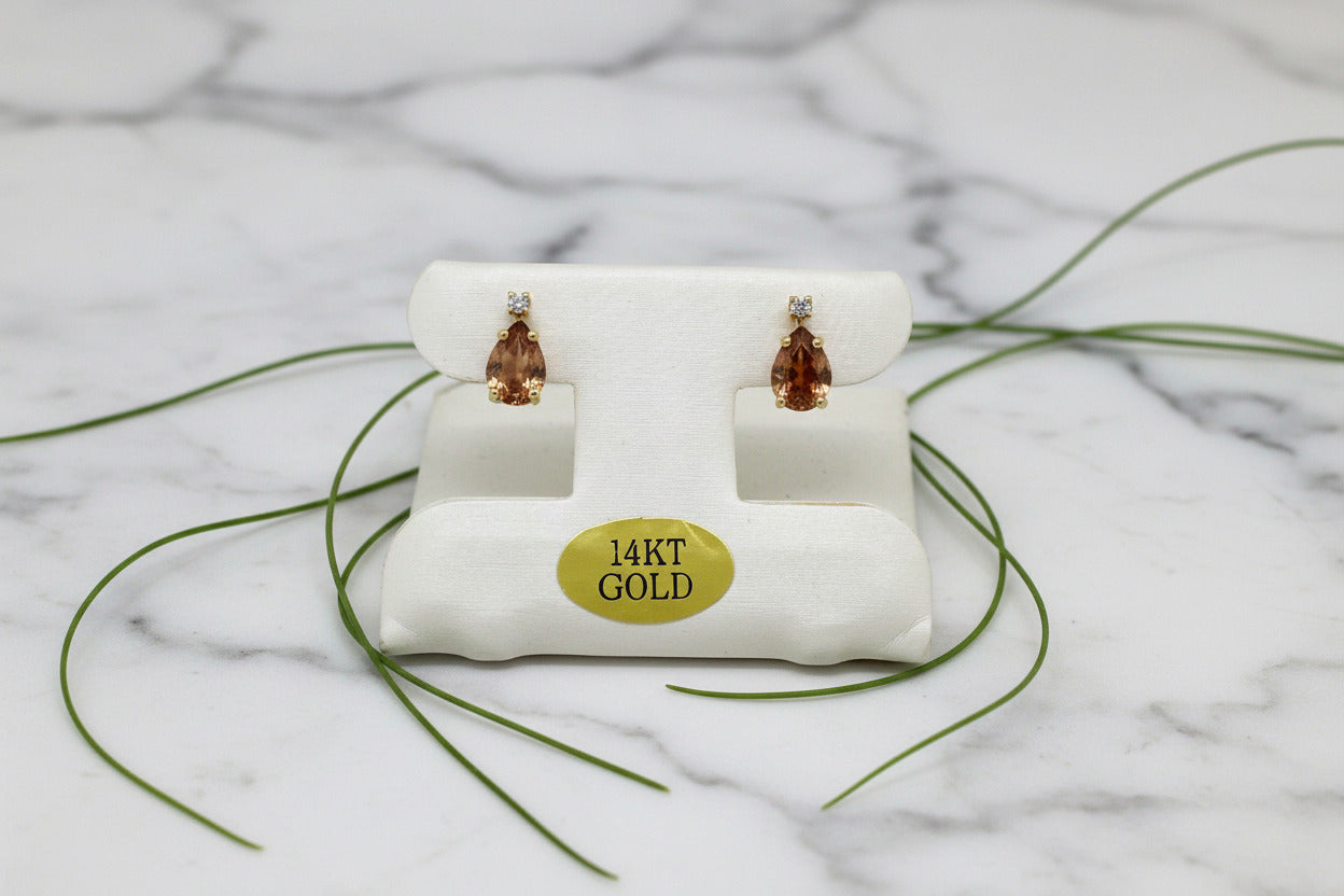 yellow gold stud earrings with peach-toned pear-shaped garnets and diamond accents