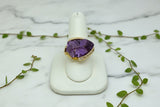18 karat yellow gold ring set with shield shape amethyst and diamond accents
