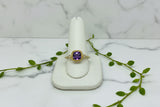yellow gold ring with cushion cut amethyst and two diamond accent stones