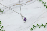 white gold necklace with asymmetrical kite-cut amethyst pendant and diamond accents