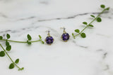 pair of yellow gold earrings with round amethyst stones and diamond accents