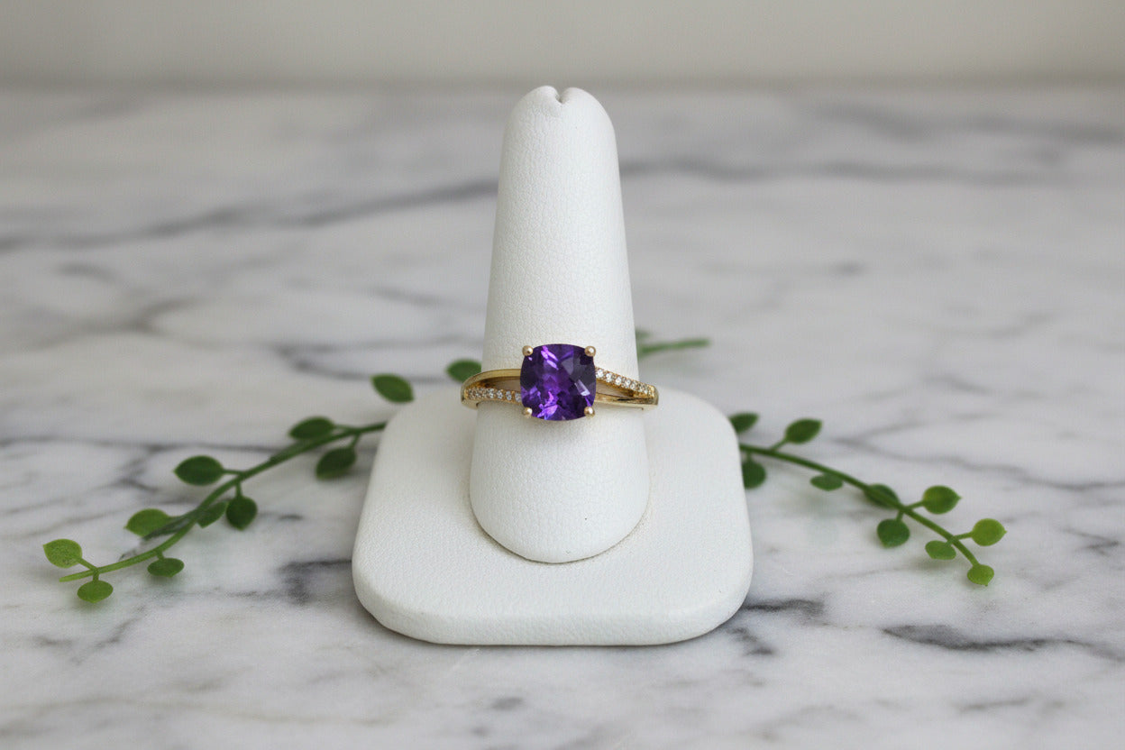 yellow gold ring with cushion cut amethyst and asymmetric diamond accents