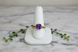 yellow gold ring with cushion cut amethyst and asymmetric diamond accents