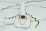 yellow gold ring with oval amethyst set east-west and asymmetric line of diamonds