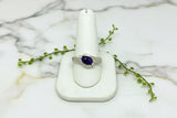 14 karat white gold asymmetric ring with oval amethyst and two small round diamonds