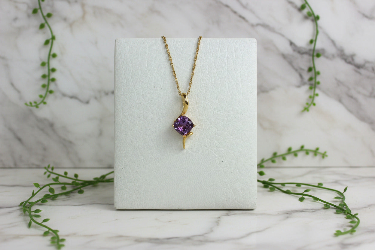 yellow gold necklace with free form design set with cushion cut amethyst