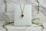 yellow gold necklace with free form design set with cushion cut amethyst