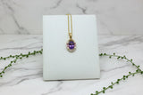 yellow gold necklace with art deco style pendant featuring amethyst, sapphire, and diamonds