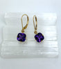 yellow gold earrings set with cushion cut amethyst