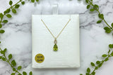 yellow gold chain and pendant set with pear shape peridot with diamond accents