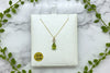 yellow gold chain and pendant set with pear shape peridot with diamond accents