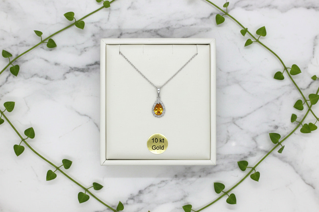 white gold necklace with pear-shaped citrine pendant with diamond halo
