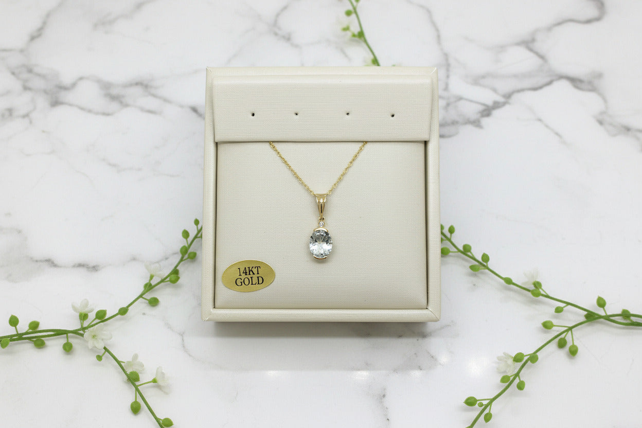 yellow gold necklace with aquamarine pendant and diamond accent