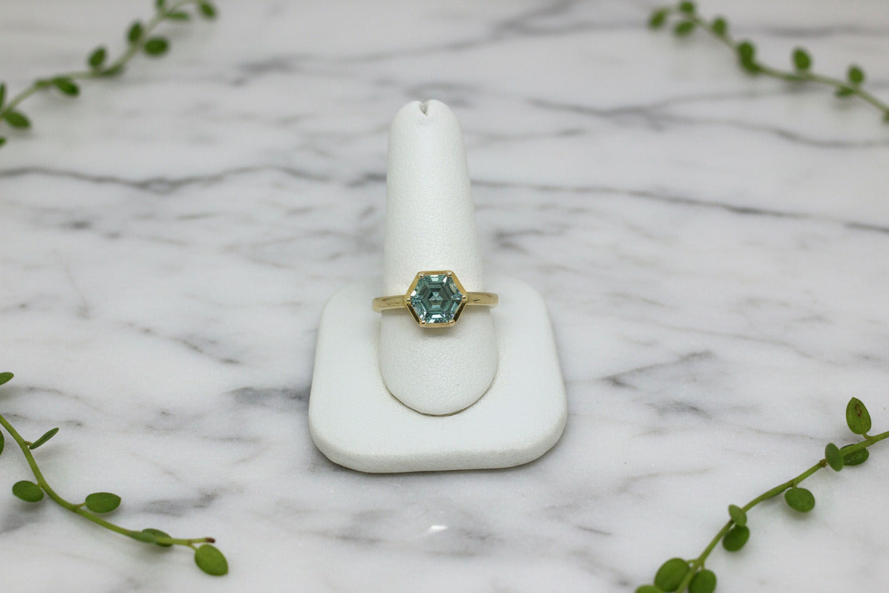 yellow gold solitaire ring set with hexagonal cut green lab-grown spinel