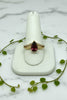 yellow gold split-shank ring with pear cut garnet center stone and two rows of diamonds