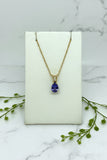 yellow gold chain and pendant set with pear shape tanzanite with diamond accent