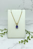 yellow gold chain and pendant set with pear shape tanzanite with diamond accent