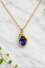 yellow gold necklace and pendant. pendant is set with an oval iolite center and accented with a ribbon of diamonds along one edge.