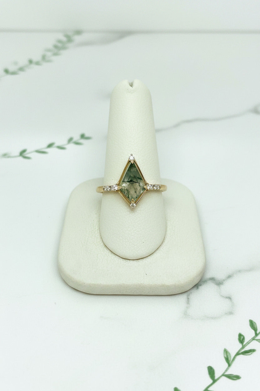 yellow gold ring with kite shaped moss agate center stone and 8 diamond accent stones