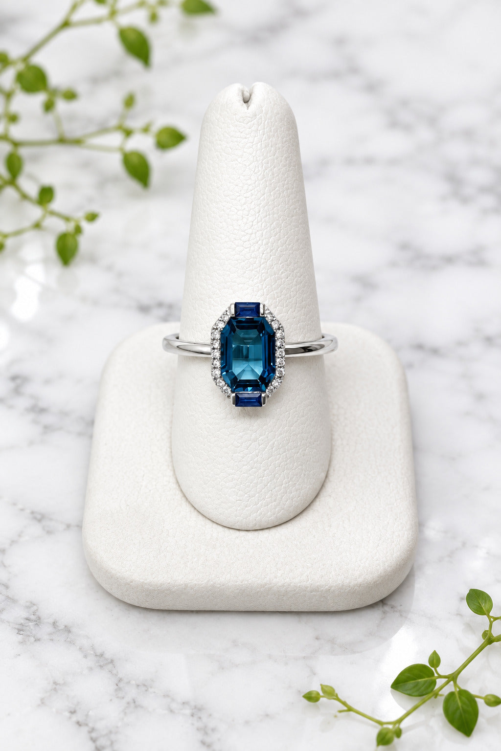 14 karat white gold ring with center london blue topaz, 2 baguette sapphires, and diamonds
