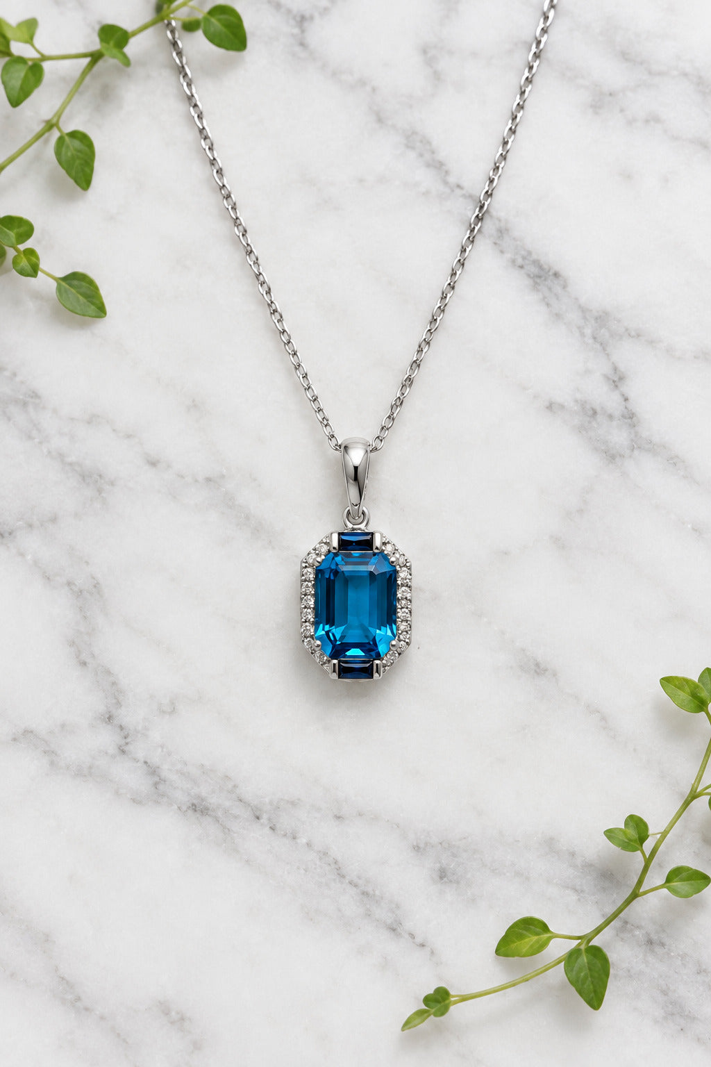 white gold necklace and pendant set with London blue topaz, blue sapphires, and accent diamonds
