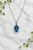 white gold necklace and pendant set with London blue topaz, blue sapphires, and accent diamonds