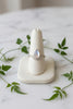 a white gold ring with a teardrop moonstone set in the center and teal sapphire accents stones
