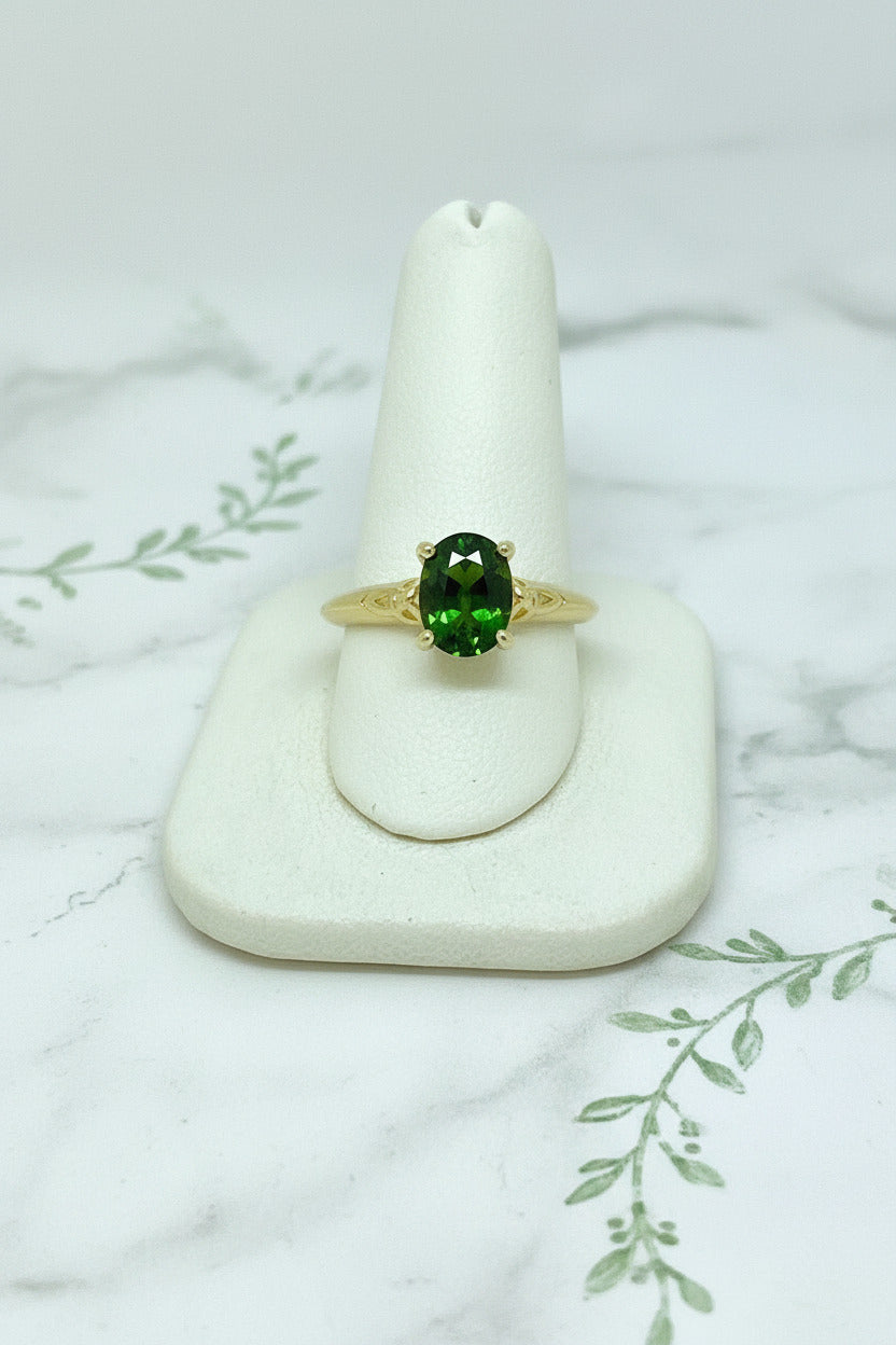 yellow gold solitaire ring with celtic design set with oval green tourmaline