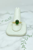 yellow gold solitaire ring with celtic design set with oval green tourmaline