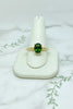 yellow gold solitaire ring with celtic design set with oval green tourmaline